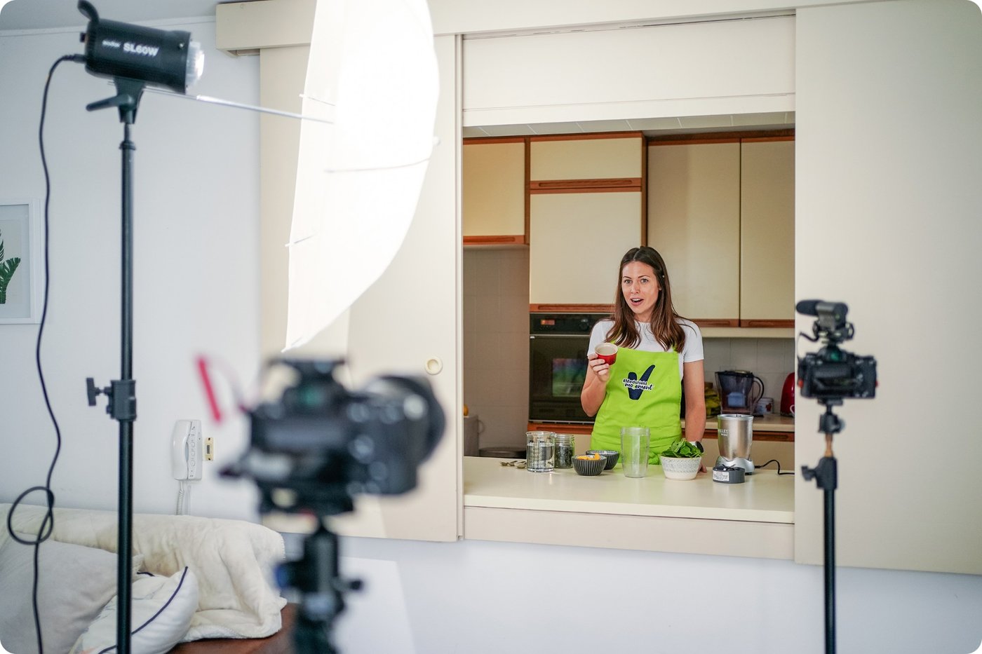 A presenter being filmed in a home kitchen studio